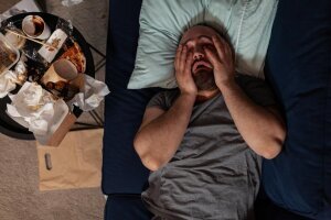 depressed_frustrated_man_despair_laying_couch_feeling_irritated_about_solitude_loneliness_desperate_sad_adult_with_chronic_depression_difficulties_having_disappointment_crisis